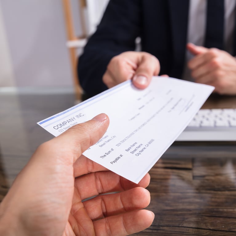 Two people handling a check_Fintelligent_Paycheck Protection